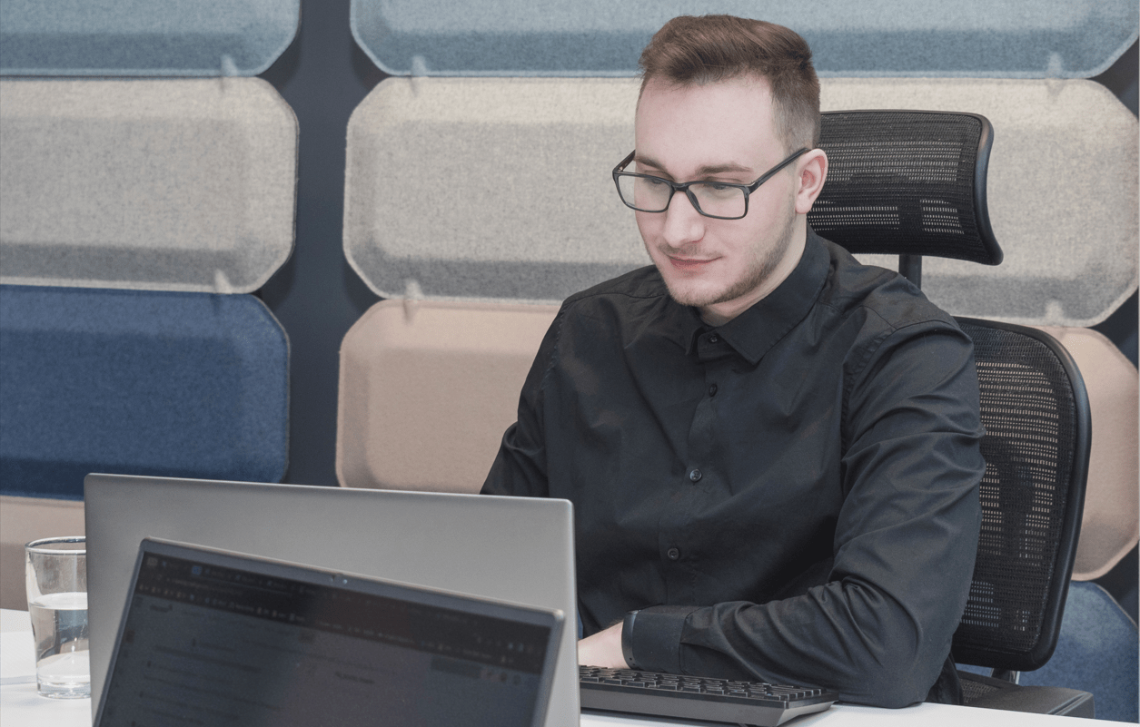 A boy sitting with computer looking at job position
